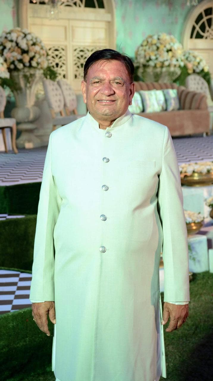 Nanu Maharaj Vedic astrologer smiling warmly in a pale green sherwani